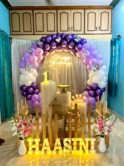 A full view of the butterfly-themed first birthday party at home, showing the complete setup with floral arrangements.