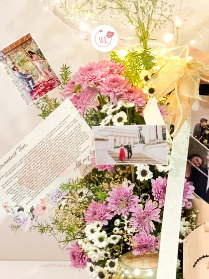 A detail shot of the floral arrangement and personalized photo cards that can be included in my bridal hampers.