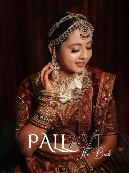 A stunning close-up portrait of the bride, highlighting her intricate matha patti and flawless makeup.
