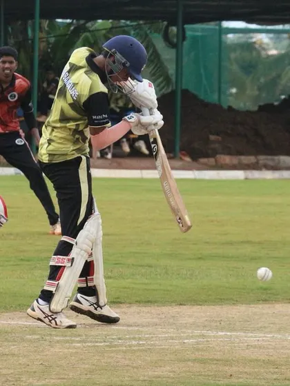 A batter connects with a shot, with the wicketkeeper and slip fielder in position.