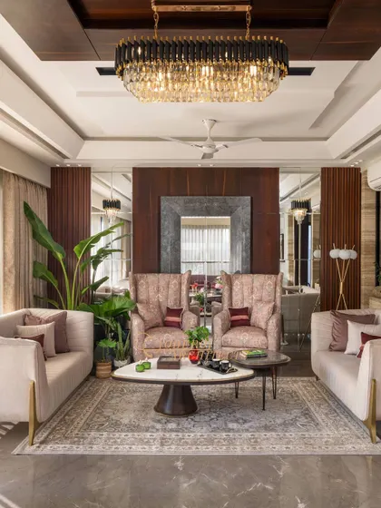A full view of the living room, where a large mirror and warm wooden interiors create a refined and sophisticated look.