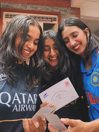 Friends in their favorite jerseys, looking at their prints from Jersey Day at Cul Week.