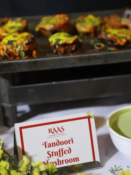 Another look at the popular Tandoori Stuffed Mushroom appetizer. The dish is garnished and served with a fresh mint chutney, making it a complete and flavourful bite.