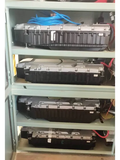 A look inside the battery cabinet of a hybrid solar system, showing the stacked Lithium-ion battery packs. These batteries, similar to those used in electric vehicles, provide reliable power during outages.