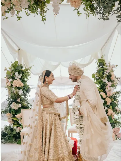 The Varmala exchange between Manchal and Luca. The bride's playful gesture and their smiles make this a delightful and memorable shot.