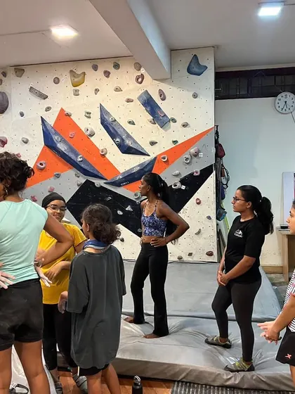 A group of climbers discussing strategy before attempting a route. Collaboration and sharing beta are a huge part of how we learn and improve together.