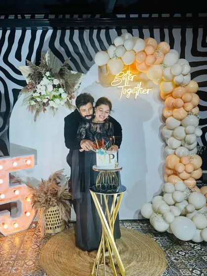 It was an honor to decorate for Lovely Star Prem and his wife's 25th anniversary. This elegant setup features a modern backdrop with a "Better Together" neon sign and a beautiful pastel balloon arch for a sophisticated celebration.