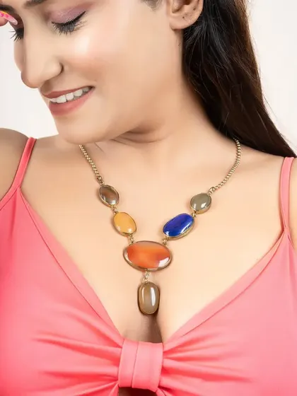 A cheerful shot of a model wearing a colorful stone necklace. This type of image is great for social media and lifestyle branding.