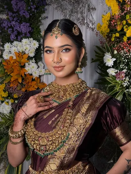 A half-length portrait of the bride, showing the beautiful fall of the pallu and the intricate details of the saree.