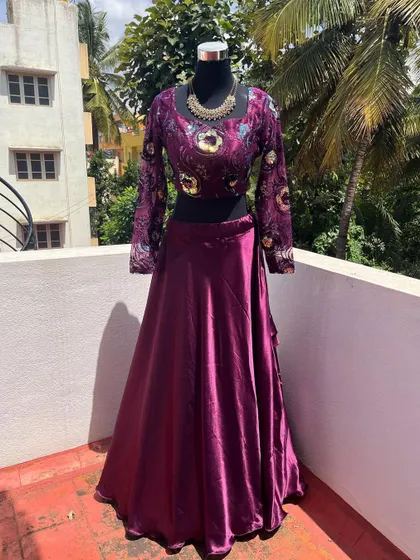 Another angle of the purple lehenga, showing its rich color and satin skirt.