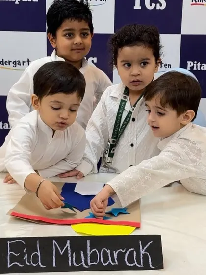 A group of boys collaborating on their Eid Mubarak craft. These activities are a great way to build social skills and celebrate cultural diversity together.