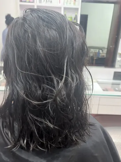 This "before" shot shows hair that is ready for a change. The client asked for smooth highlights with a Kerashine treatment to tame frizz and add gloss.