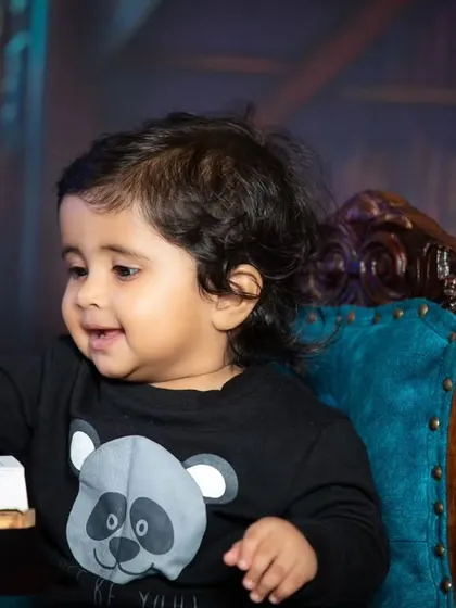 This little scholar is taking a break from reading to smile for the camera.