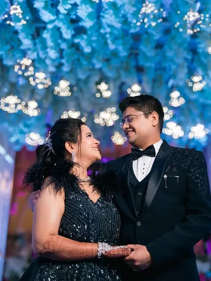 A touch of glamour for a modern engagement. We captured this couple under a stunning floral ceiling, lost in each other's eyes. It shows how we can create a grand, cinematic feel for your special evening.