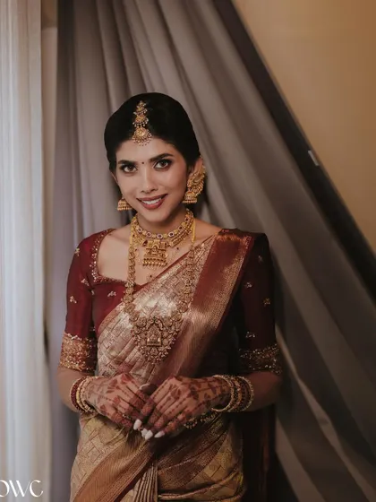 A classic bridal portrait against a simple backdrop, allowing the bride's beauty and her magnificent jewellery to shine.