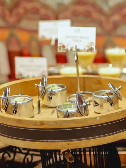 A closer look at our unique serving style for Chicken Malai Tikka. The mini pressure cookers keep the appetizer warm and add a whimsical touch to the food display.
