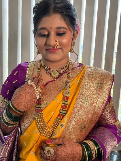 Adjusting the beautiful pearl mundavalya, a significant part of the Maharashtrian bridal look.