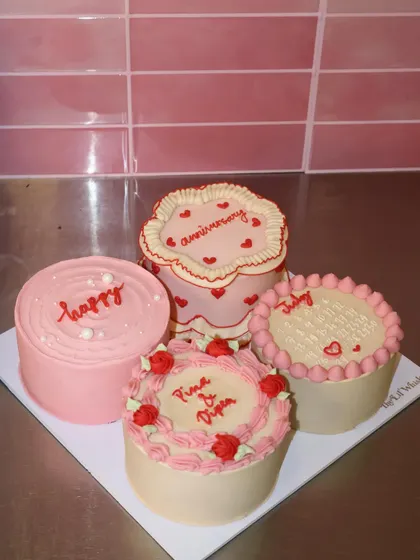 We are totally obsessed with this romantic set of four mini cakes. Featuring delicate piping, hearts, and roses in shades of pink and cream, this collection is perfect for an anniversary or to celebrate someone you love.