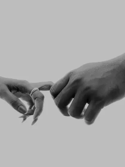A close-up of their hands making a pinky promise. This black and white shot is a beautiful symbol of their commitment.