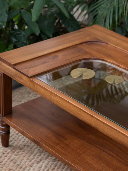 Different views of the Kulam collection, including the side table and center table. These images showcase the blend of solid teak, glass, and narrative brass accents that define this collection.