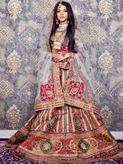 A truly regal bridal lehenga featuring rich, multi-colored embroidery. This outfit is perfect for the bride who wants a unique and majestic look, combining traditional craftsmanship with a distinctive color palette.