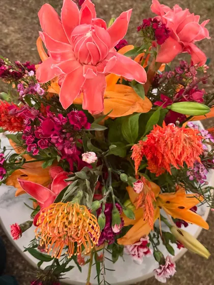 Golden blooms for a golden evening. For this wedding dinner party, our ceiling floral installations with warm, autumnal colors set a soft, wild, and glowing scene as the evening unfolded.