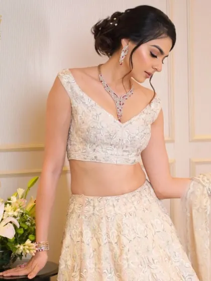 Your special day deserves extra sparkle. This bride looks radiant in our ruby and diamond necklace set, a perfect blend of colour and brilliance for a memorable occasion.