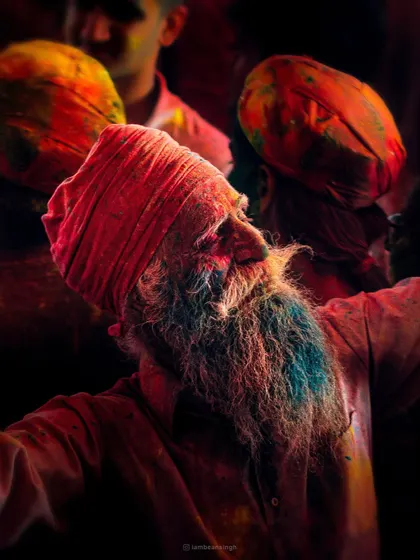 Amidst the frenzy of Holi, I captured this moment of serene joy on an elderly man's face. His beard is colored blue, and his expression is one of pure bliss, a reminder that peace can be found even in the midst of chaos.