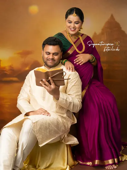 A sweet moment between the couple as they share a look, both dressed in elegant traditional clothing.