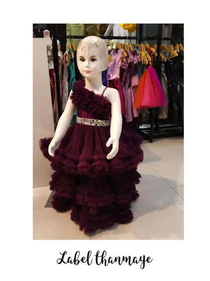 This wine-colored party dress is full of texture, with layers of ruffled tulle from top to bottom.