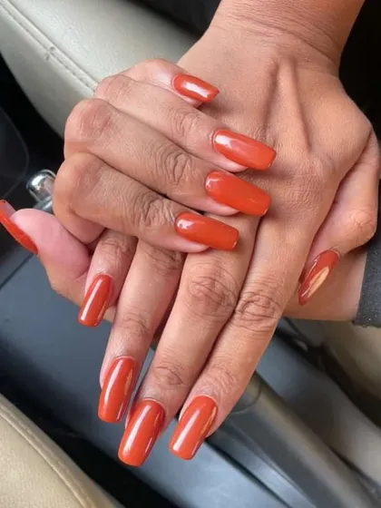 Friday night ready with these long, square-shaped nails in a stunning burnt orange color. A perfect, bold look for the weekend.
