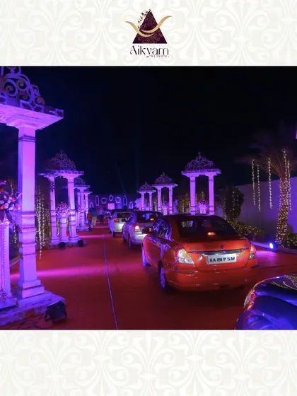 A grand driveway entrance lined with ornate, illuminated pillars. This creates a royal and spectacular welcome for guests arriving by car.