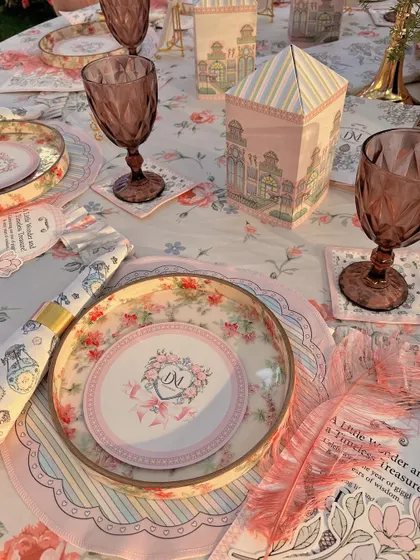 Detailed tablescape with custom-printed menus, coasters, and miniature house-shaped favor boxes.
