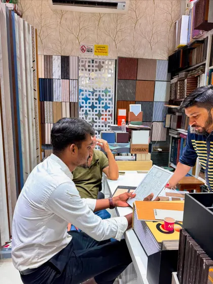 A wider view of the material selection process, surrounded by samples of laminates, veneers, and decorative panels.
