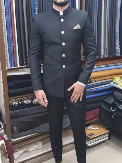 A client trying on his new black Jodhpuri suit right here in my shop. You can see the sharp fit and how the fabric drapes perfectly.
