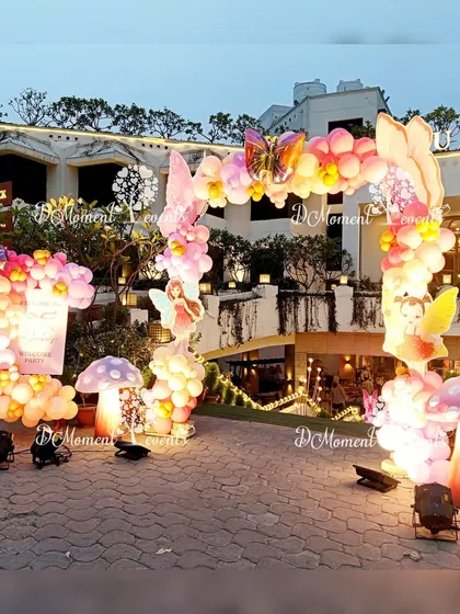 A wider view of the stunning outdoor fairy and butterfly entrance arch, showing how it transforms the entire front of the venue.