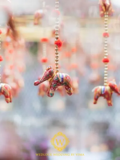 For this Varapuja ceremony, we used a vibrant palette of reds and pinks. The decor included hanging elephant charms and a mirrored backdrop to create a festive and prosperous atmosphere.