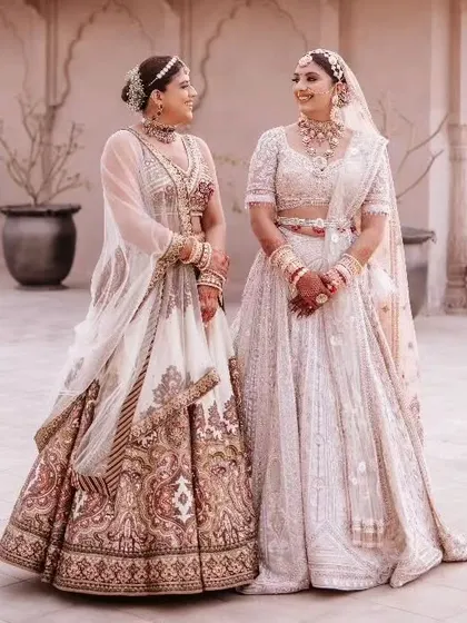 A beautiful family portrait showing the bride with her mother and sister, all dressed in coordinated ivory outfits, capturing a moment of love and togetherness before the ceremony.