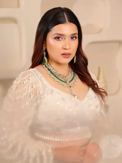 A soft, dreamy shot of the white pearl lehenga. The focus is on the intricate beadwork and the elegant silhouette, making it a showstopper for any event.