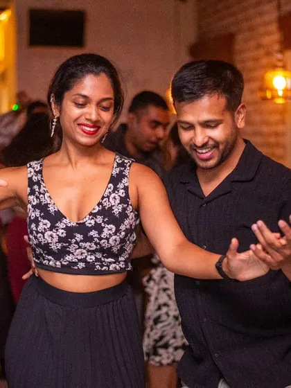 A stylish and confident pair on the dance floor.