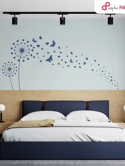 A dreamy dandelion and butterfly stencil design adds a sense of movement and lightness to this bedroom wall. It's a perfect way to add a personal and artistic touch.