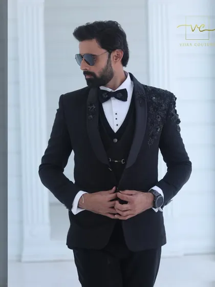 Our bespoke black tuxedo featuring intricate floral embroidery on the shoulders. The tone-on-tone black beadwork creates a subtle yet luxurious texture, perfect for an evening reception.