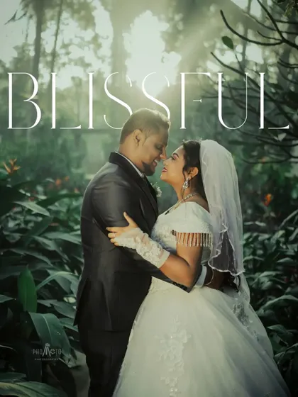 'Blissful'. A romantic portrait of the couple in a lush, green forest, the sunlight creating a magical halo effect.