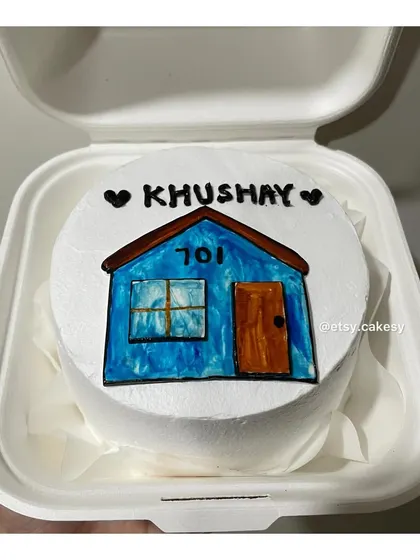 A custom bento cake with a drawing of a house, perfect for a housewarming.