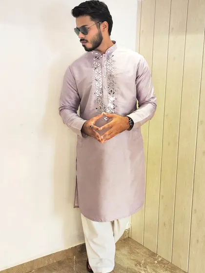 A client wearing a trendy lavender kurta with original mirror work embroidery on the placket, paired with a white salwar.