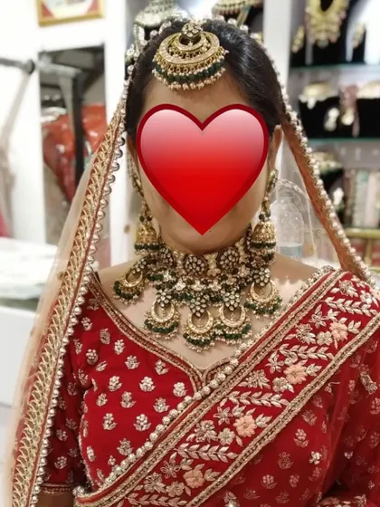 A client trying on a heavy green meenakari and Kundan bridal set in my store. I always help my clients find the perfect match for their big day.