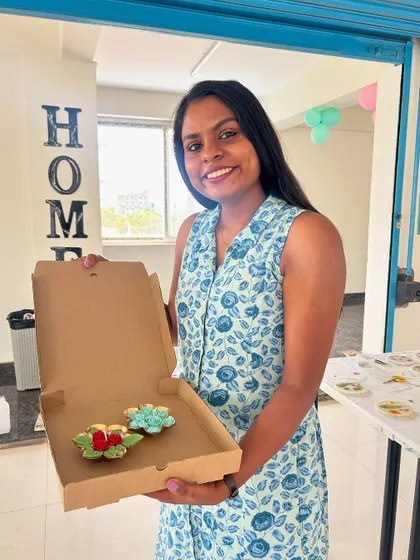 This guest is boxing up her handmade floral diya candles, perfect for gifting or for festive decorations.