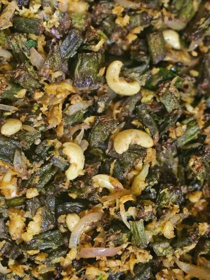 A close-up of our Bendakaya Vepudu (okra fry), a delicious and crispy Andhra specialty, garnished with cashews.