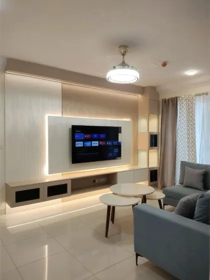 The full composition of a modern living room, featuring a sleek TV unit with ambient backlighting, a comfortable L-shaped sofa, and nesting coffee tables. Every element is designed to work in harmony, creating a balanced and inviting atmosphere.