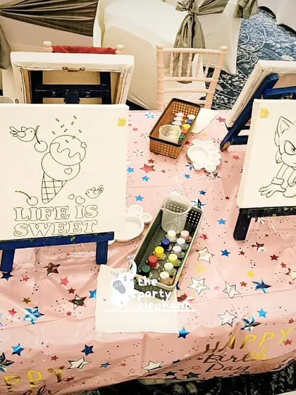 A canvas painting station with pre-drawn characters and sweet treats. This is one of our popular art activities that lets kids unleash their creativity.
